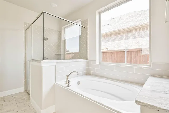 a bathroom with a bathtub and a window