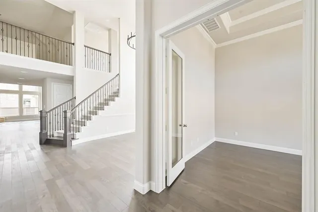 a view of entryway and hall with wooden floor