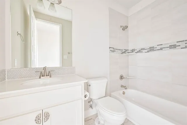 a bathroom with a sink a toilet and a bathtub