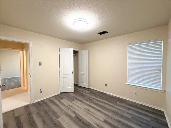 a view of room with wooden floor and fan