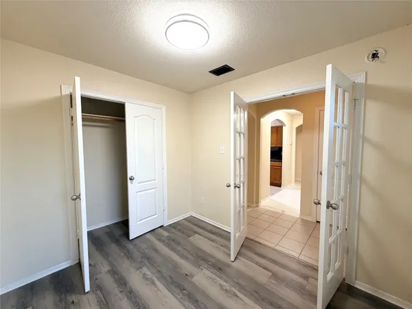 an empty room with a fireplace and windows