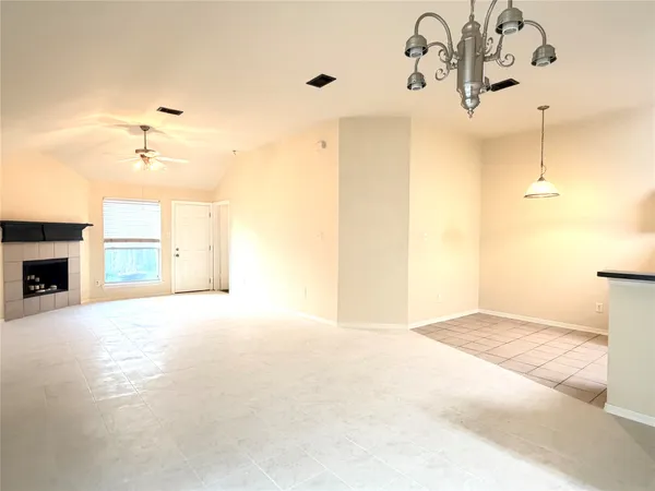 a view of kitchen with refrigerator and window