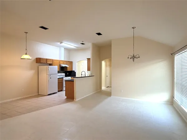 a kitchen with refrigerator and cabinets