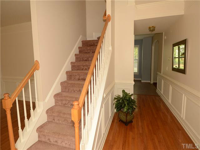 1114 Blackburn Road Apex, NC 27502 - Photo 2 of 17 Beautiful hardwood floors in foyer accented by wainscoating