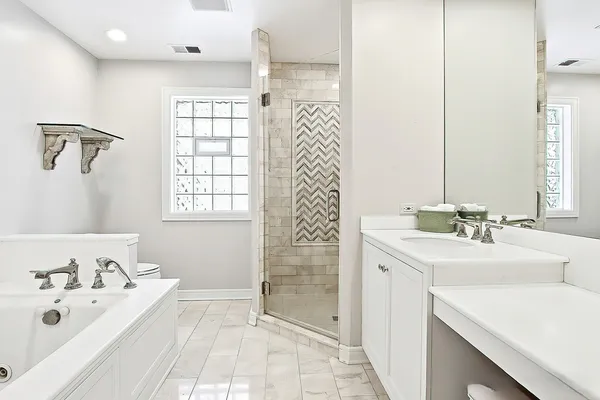 a bathroom with a tub sink and mirror