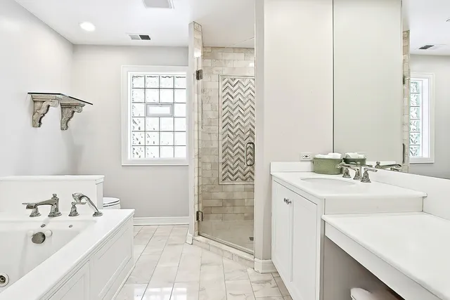 a bathroom with a sink a tub and a mirror