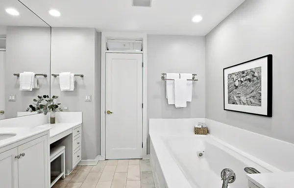 a bathroom with a sink a tub and a mirror