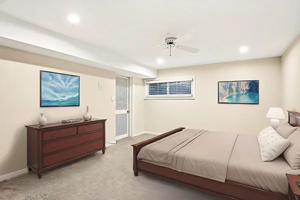 a bedroom with a bed and a painting on the wall