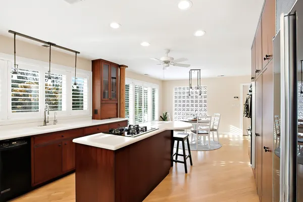 a kitchen with a sink stove and chairs