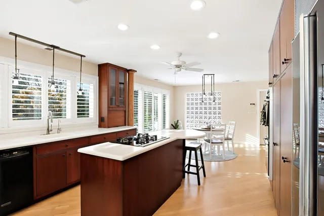a kitchen with a table chairs and chandelier