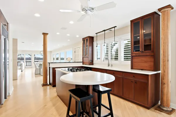a kitchen with a table chairs and chandelier