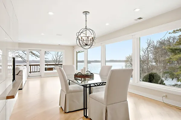 a dining room with furniture a chandelier and wooden floor