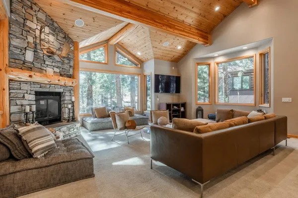 a living room with furniture a fireplace and a large window