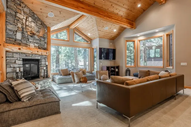 a living room with furniture a fireplace and a large window