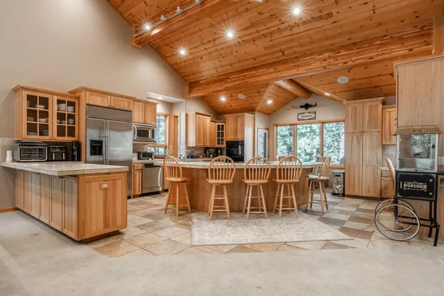 a dining room with furniture a chandelier and wooden floor