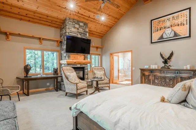a bedroom with a bed and a couch next to a window