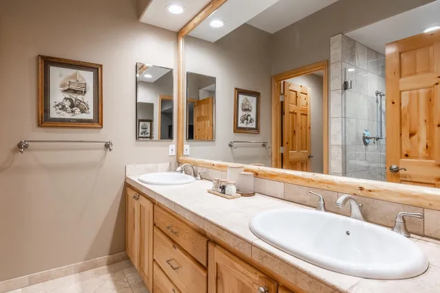 a spacious bathroom with a tub sink shower and mirror