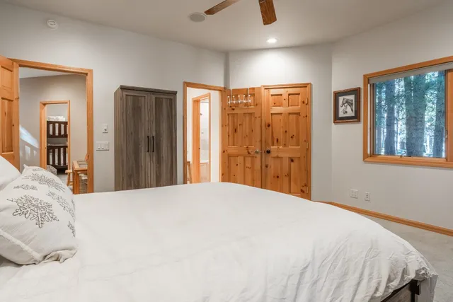 a bed sitting in a bedroom next to a window