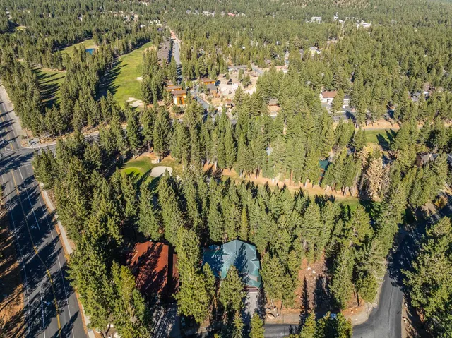 a house that has a tree in front of the house