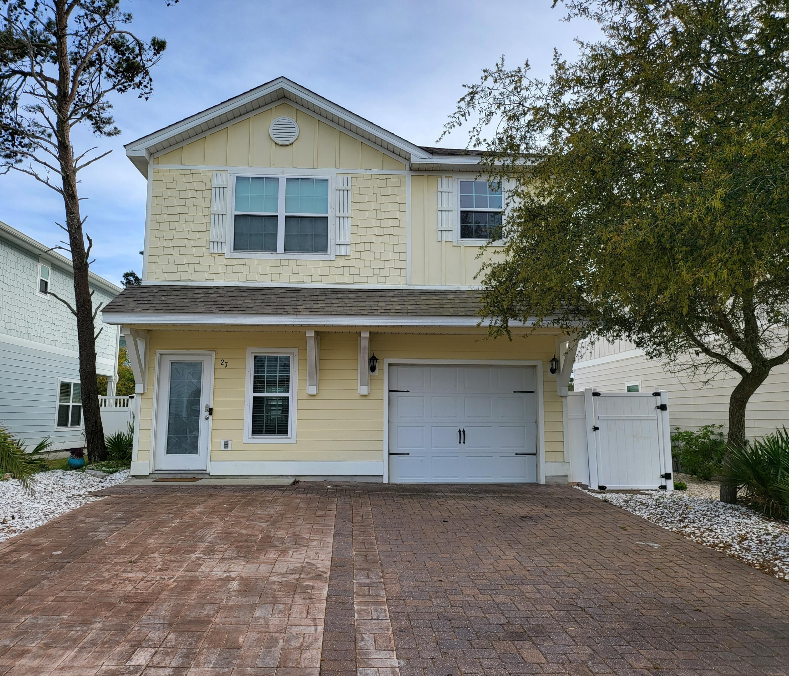a view of a house with a yard and garage