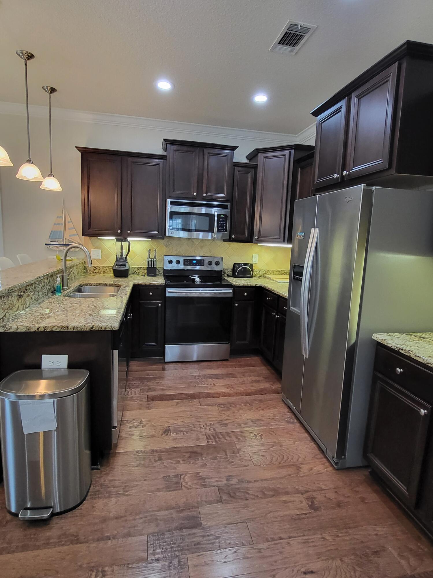 27 Topside Drive Inlet Beach, FL 32461 - Photo 11 of 33 a kitchen with stainless steel appliances granite countertop a stove a sink dishwasher a refrigerator and a oven