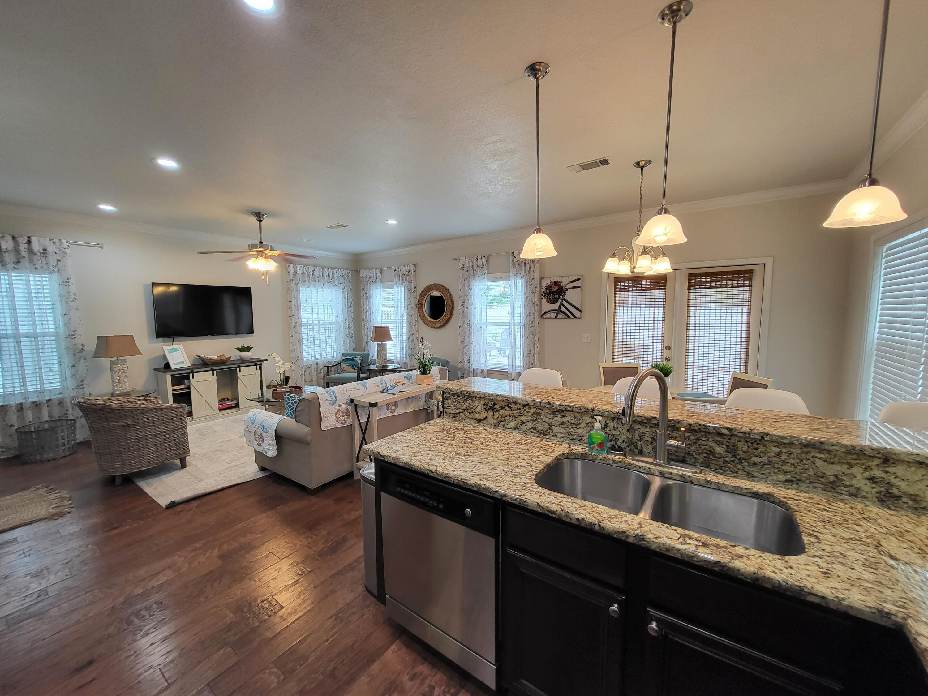 27 Topside Drive Inlet Beach, FL 32461 - Photo 13 of 33 a kitchen with center island a sink dishwasher a living room with furniture and a flat screen tv