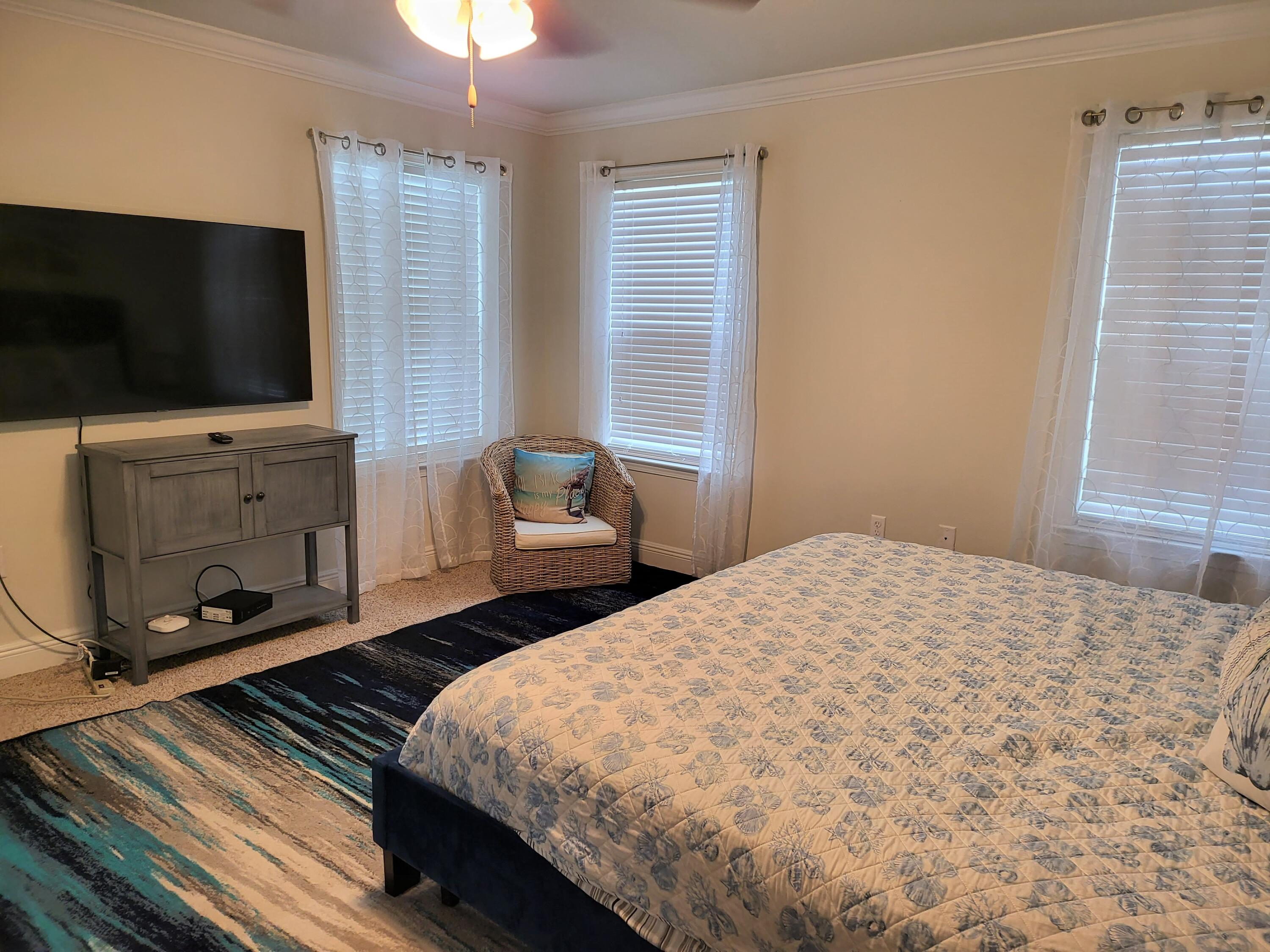 27 Topside Drive Inlet Beach, FL 32461 - Photo 25 of 33 a bedroom with a bed and a flat tv screen on dresser
