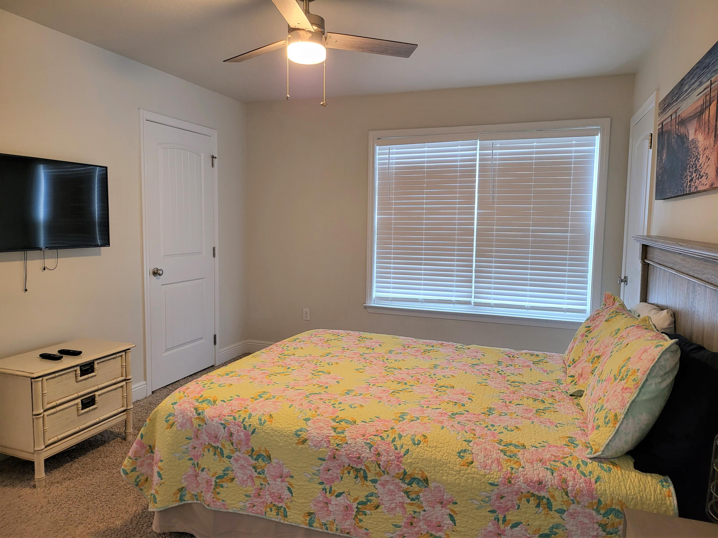27 Topside Drive Inlet Beach, FL 32461 - Photo 27 of 33 a bedroom with a bed and a flat tv screen on dresser