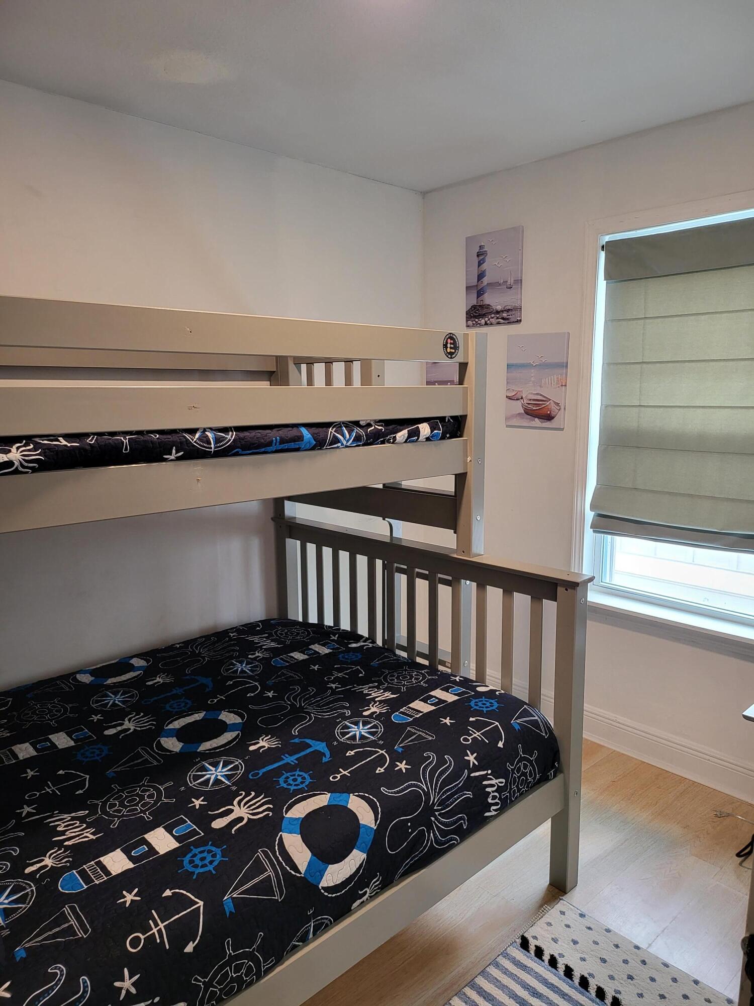27 Topside Drive Inlet Beach, FL 32461 - Photo 29 of 33 a bedroom with a bed and wooden floor