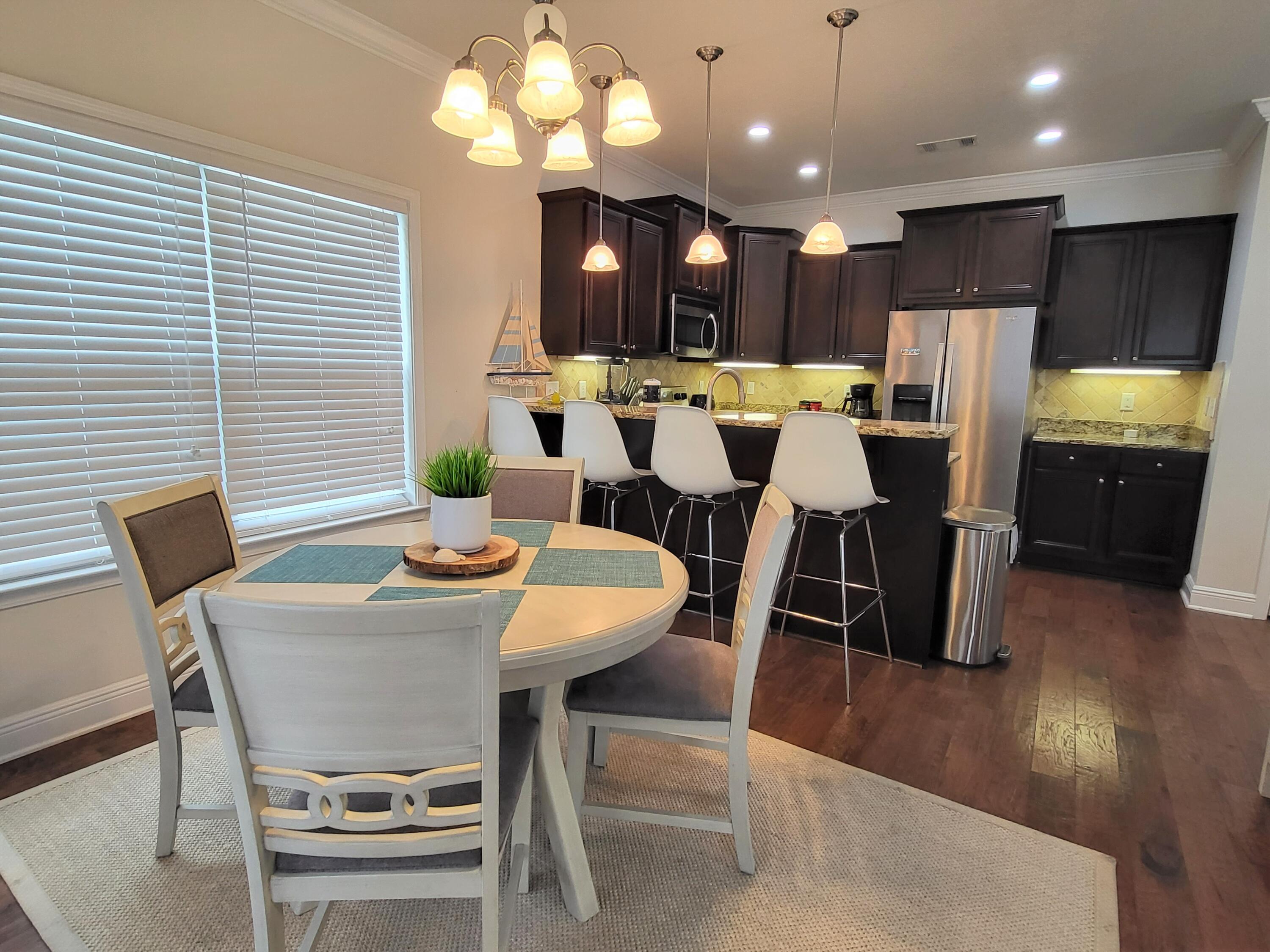 27 Topside Drive Inlet Beach, FL 32461 - Photo 10 of 33 a view of a dining room with furniture and wooden floor