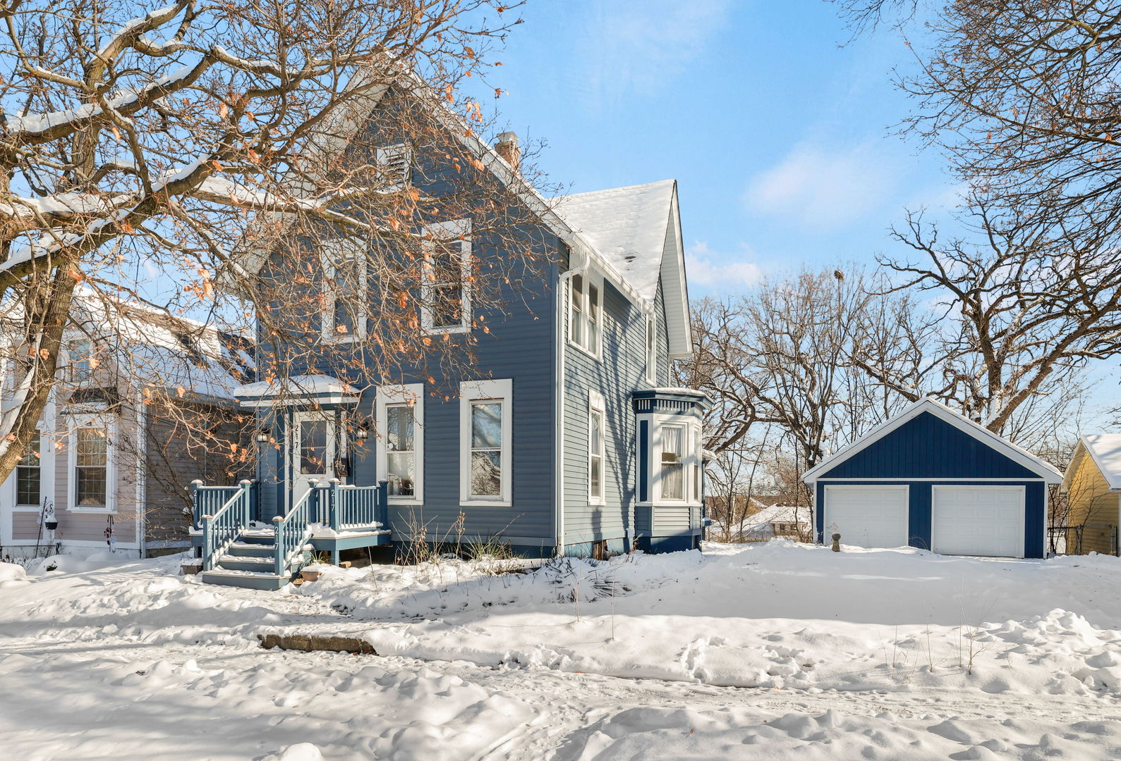 a view of a house with snow on the road