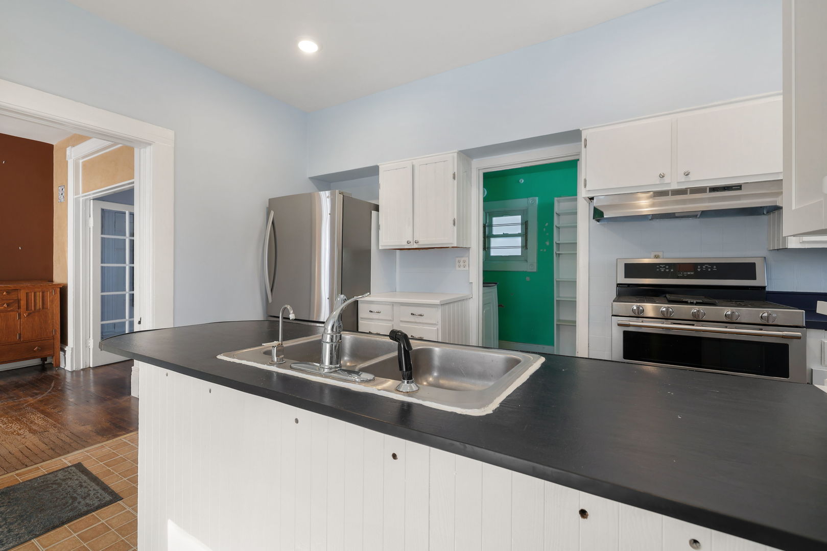 217 Henry Street Elgin, IL 60120 - Photo 6 of 17 a kitchen with kitchen island a sink appliances and cabinets