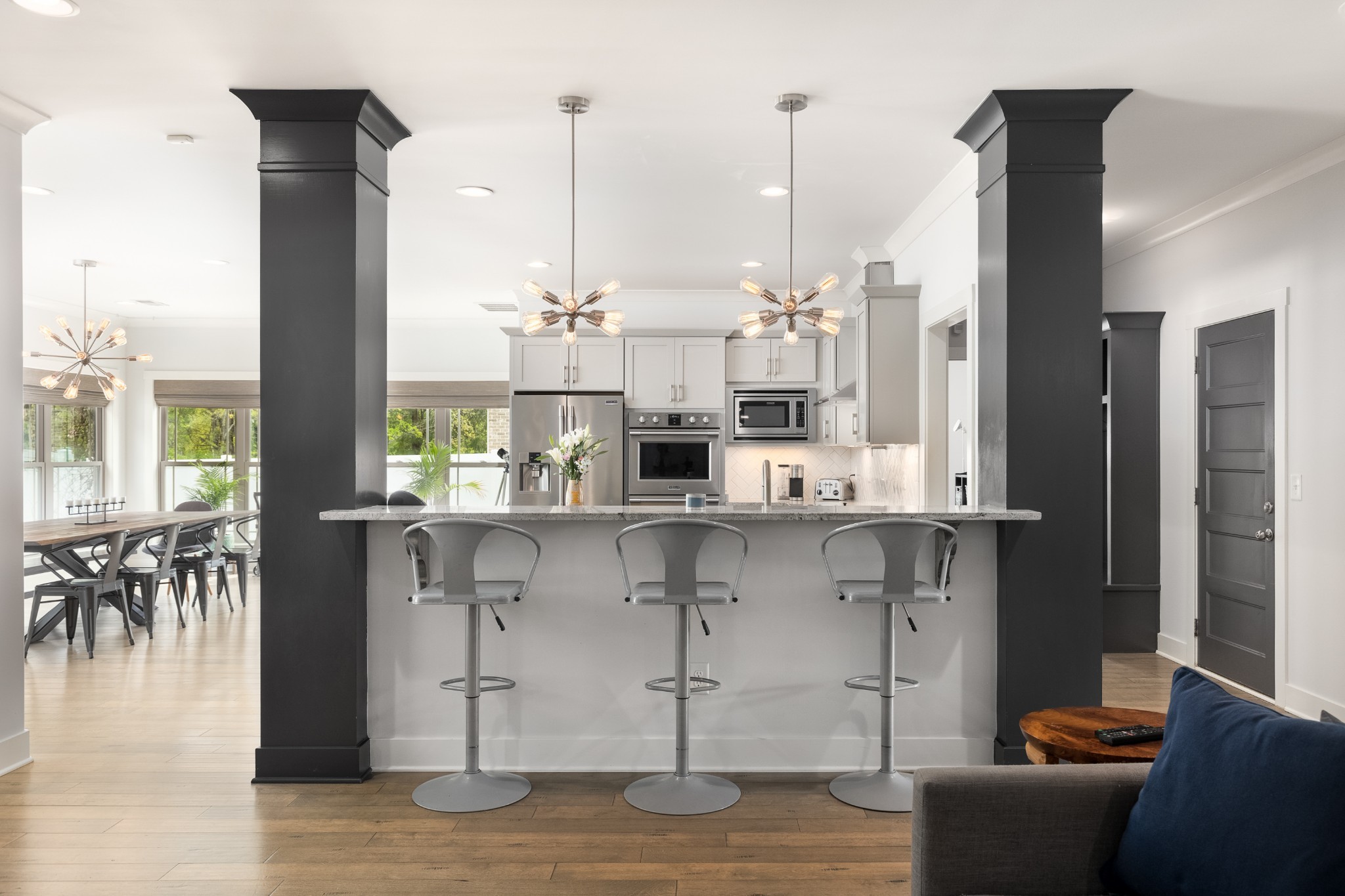 7970 Richpine Drive Murfreesboro, TN 37128 - Photo 4 of 30 a kitchen with stainless steel appliances kitchen island granite countertop a table chairs and a view of living room