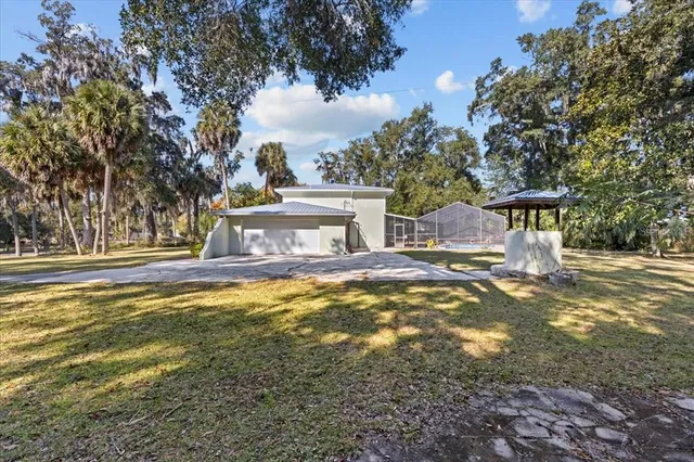 a view of a kitchen with a stove a ceiling fan and wooden floor
