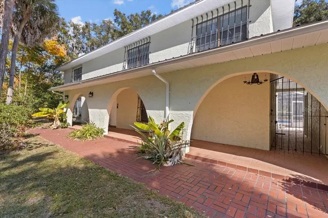 a kitchen with stainless steel appliances granite countertop a refrigerator a sink dishwasher a stove and white cabinets with wooden floor