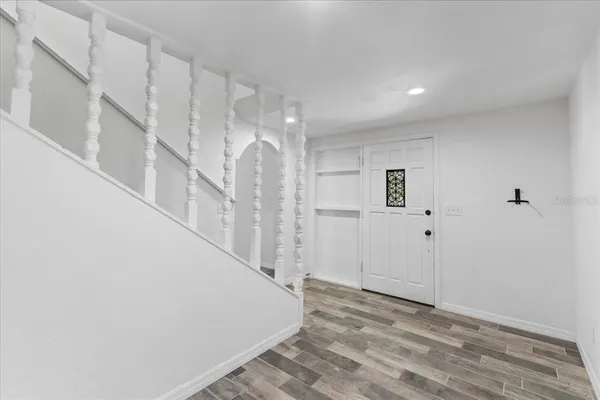 a kitchen view with stainless steel appliances granite countertop a sink window and a refrigerator