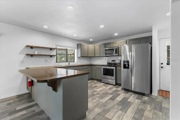 a living room with furniture a bookshelf and a window