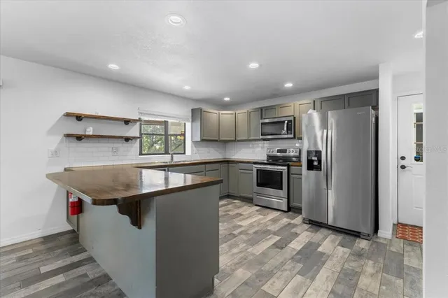 a living room with furniture a bookshelf and a window