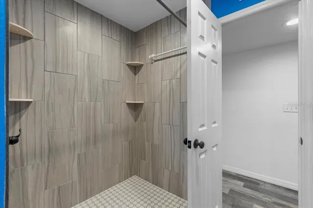 a bed room with a bed a potted plant and a window