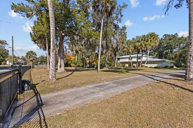 an aerial view of house with yard and mountain view in back