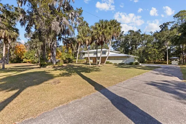 an aerial view of residential house with green space