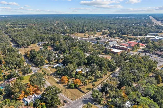 a view of a blue house with a bench