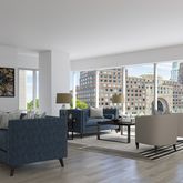 a living room with furniture and large windows