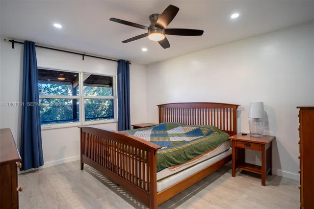 a bedroom with furniture and a window