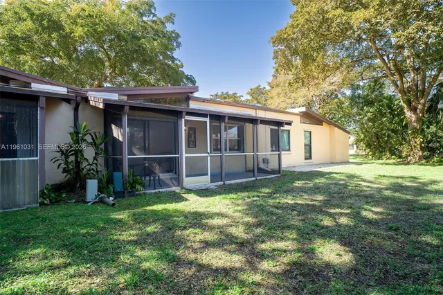 a view of a house with a yard and plants