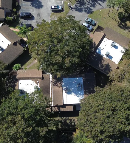 an aerial view of a house with a yard