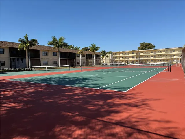 a view of a big room with a big yard and large trees