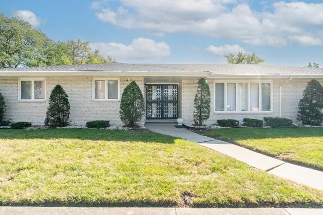 front view of house with yard outdoor seating and barbeque oven