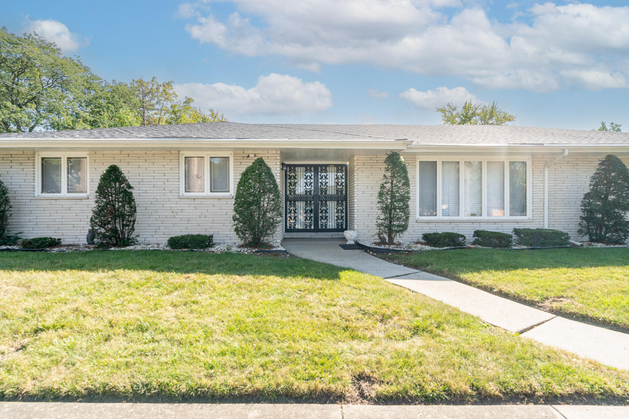 front view of house with yard outdoor seating and barbeque oven
