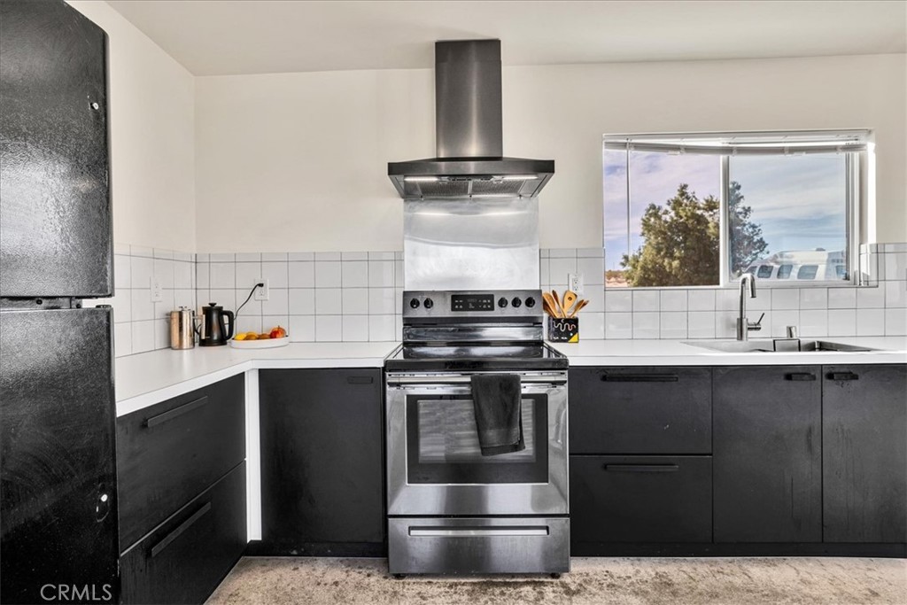 2625 Geronimo Trail Yucca Valley, CA 92285 - Photo 11 of 57 a kitchen with a stove and a sink